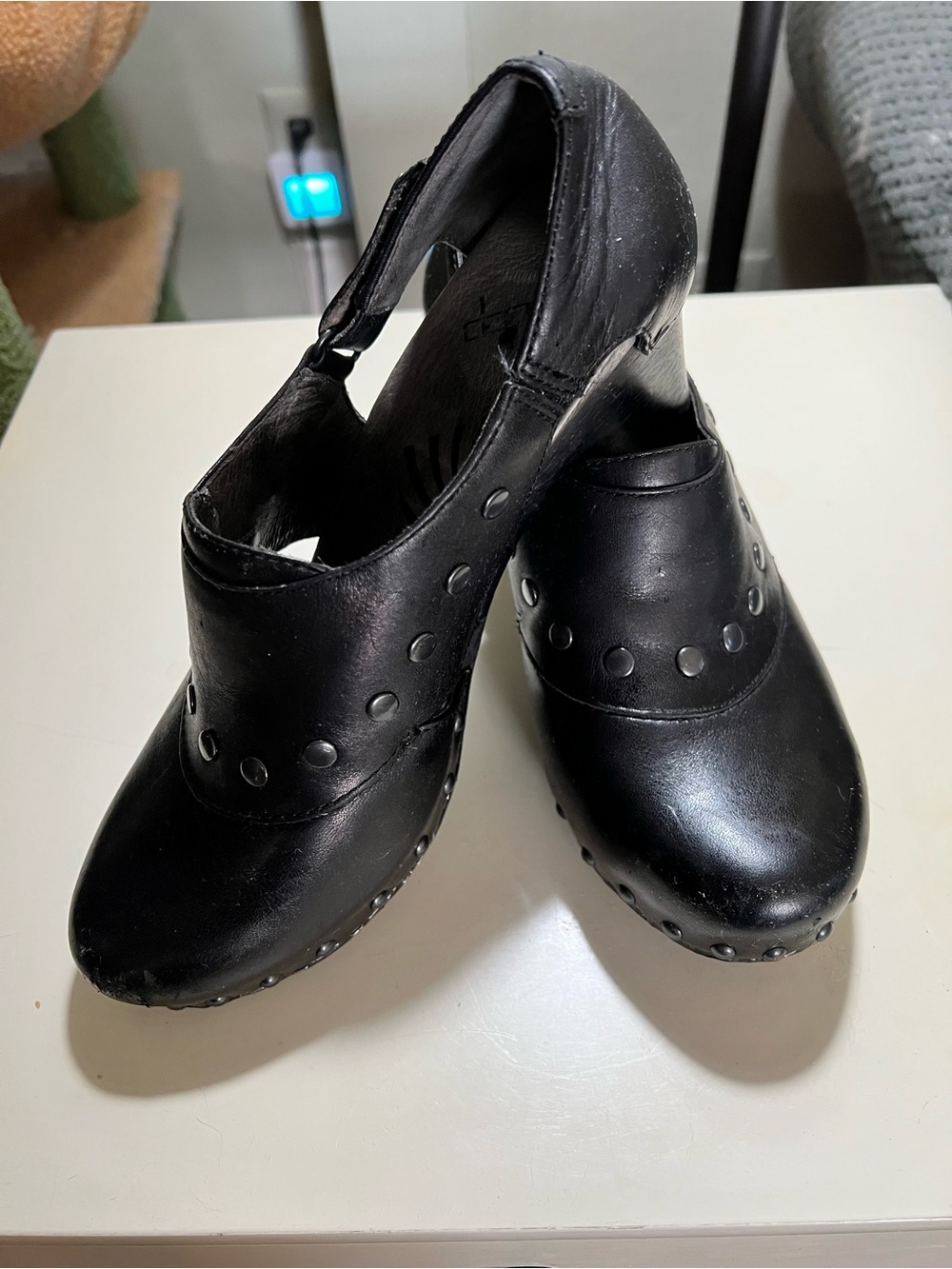Dansko Ryder Black Leather clogs with silver studded details and block heels.